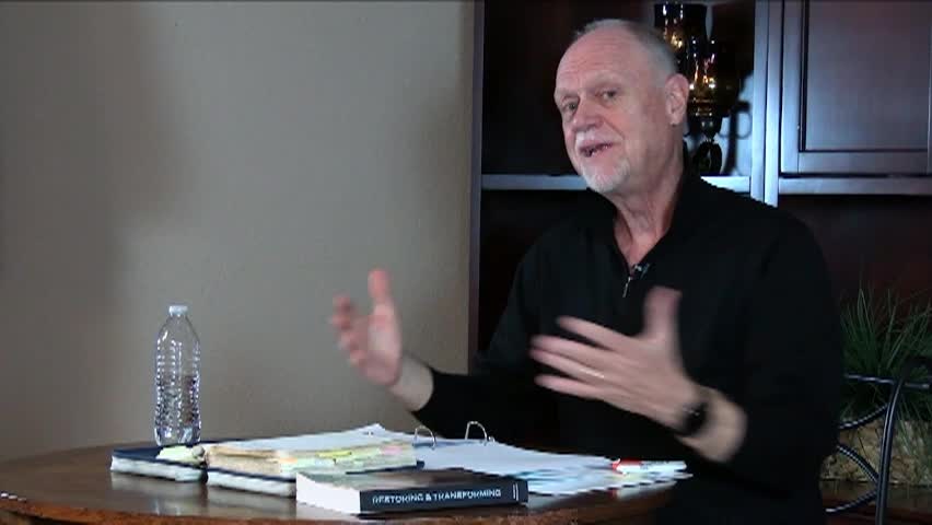 An older man seated at a desk