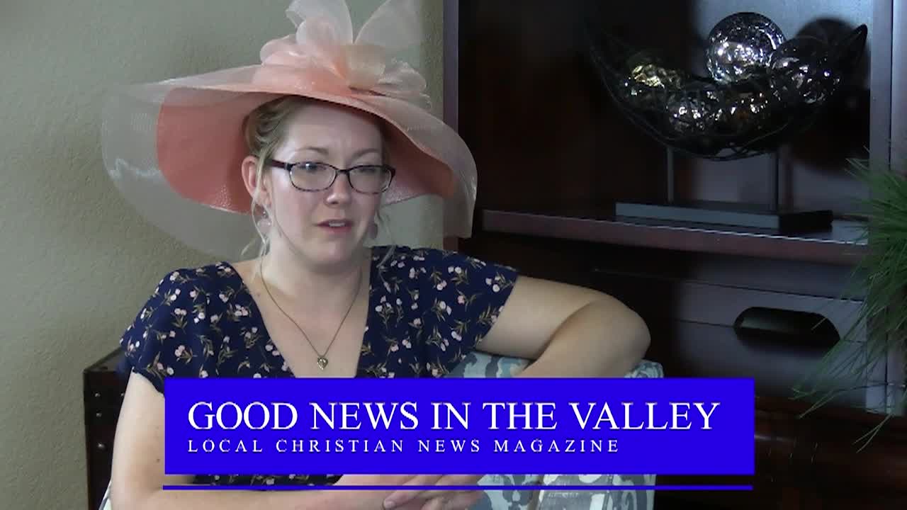 A woman seated wearing a pink hat